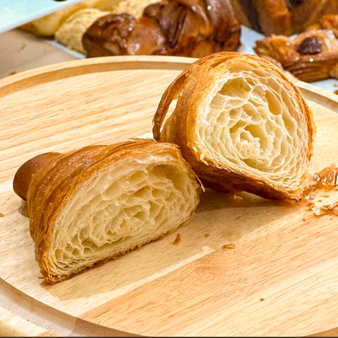 Freshly baked golden croissants with flaky layers and soft, airy interiors, available at the best bakery in Bangkok.